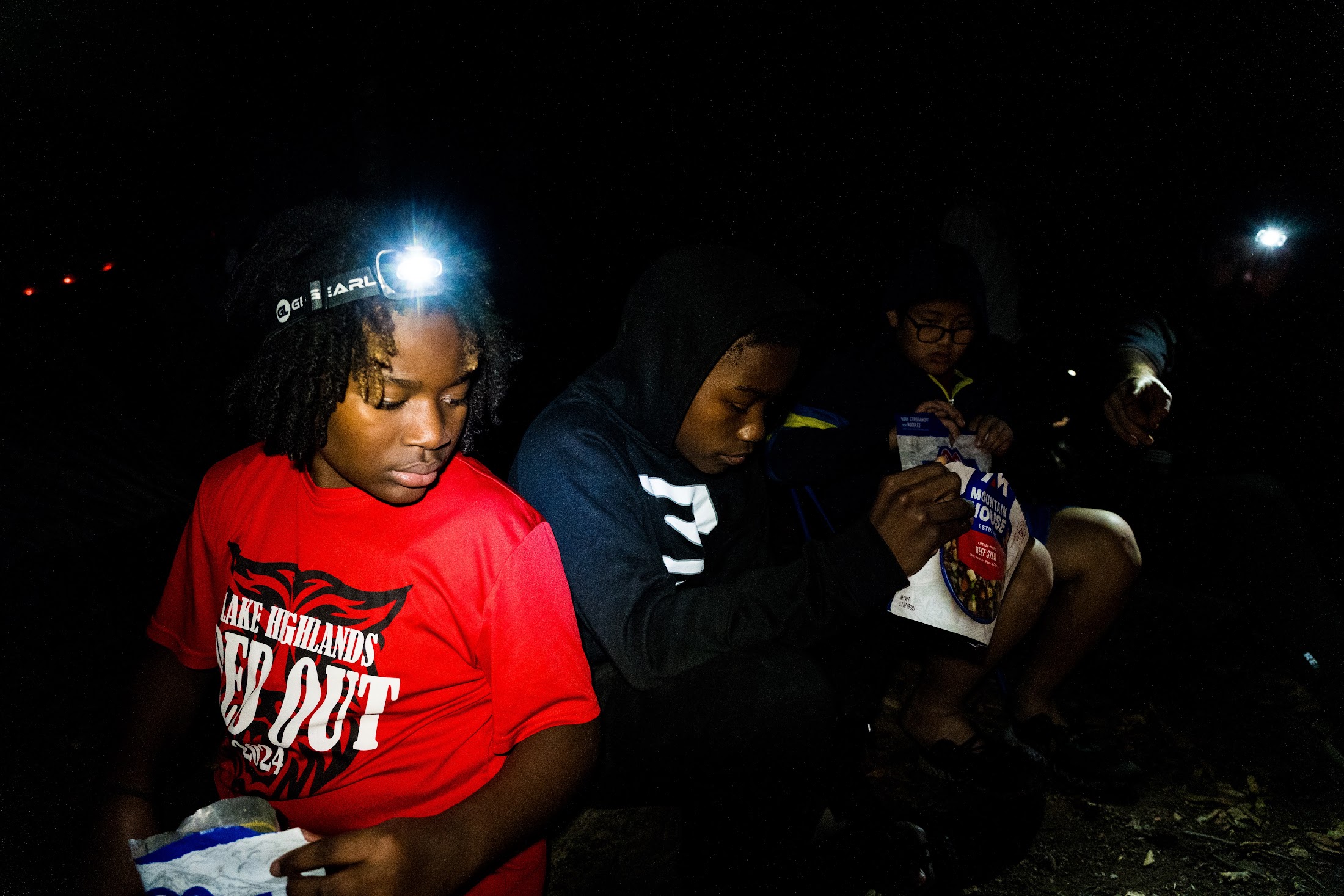 Camp Firewalker participants sharing a meal outdoors