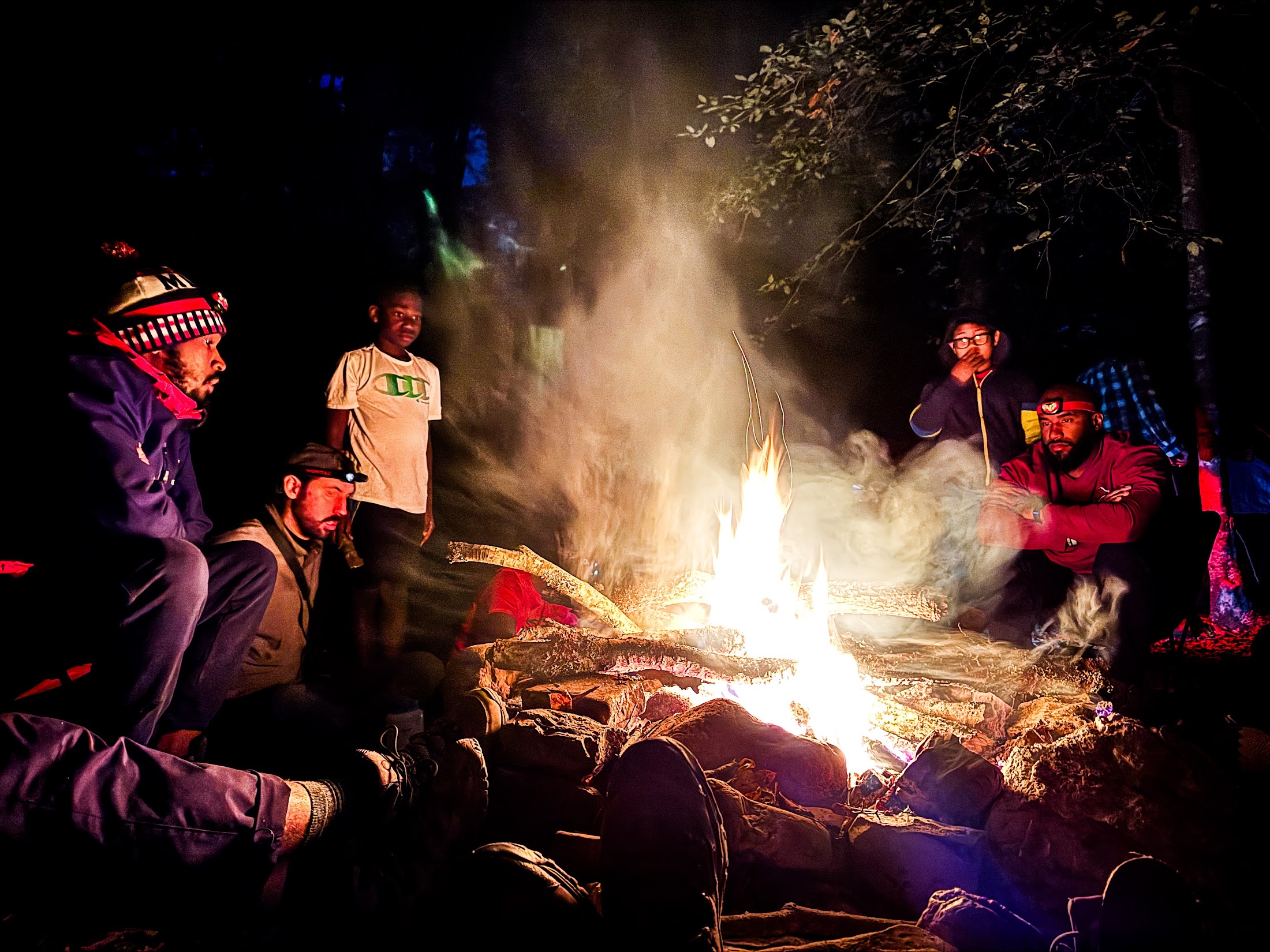 Camp Firewalker group gathered around a campfire