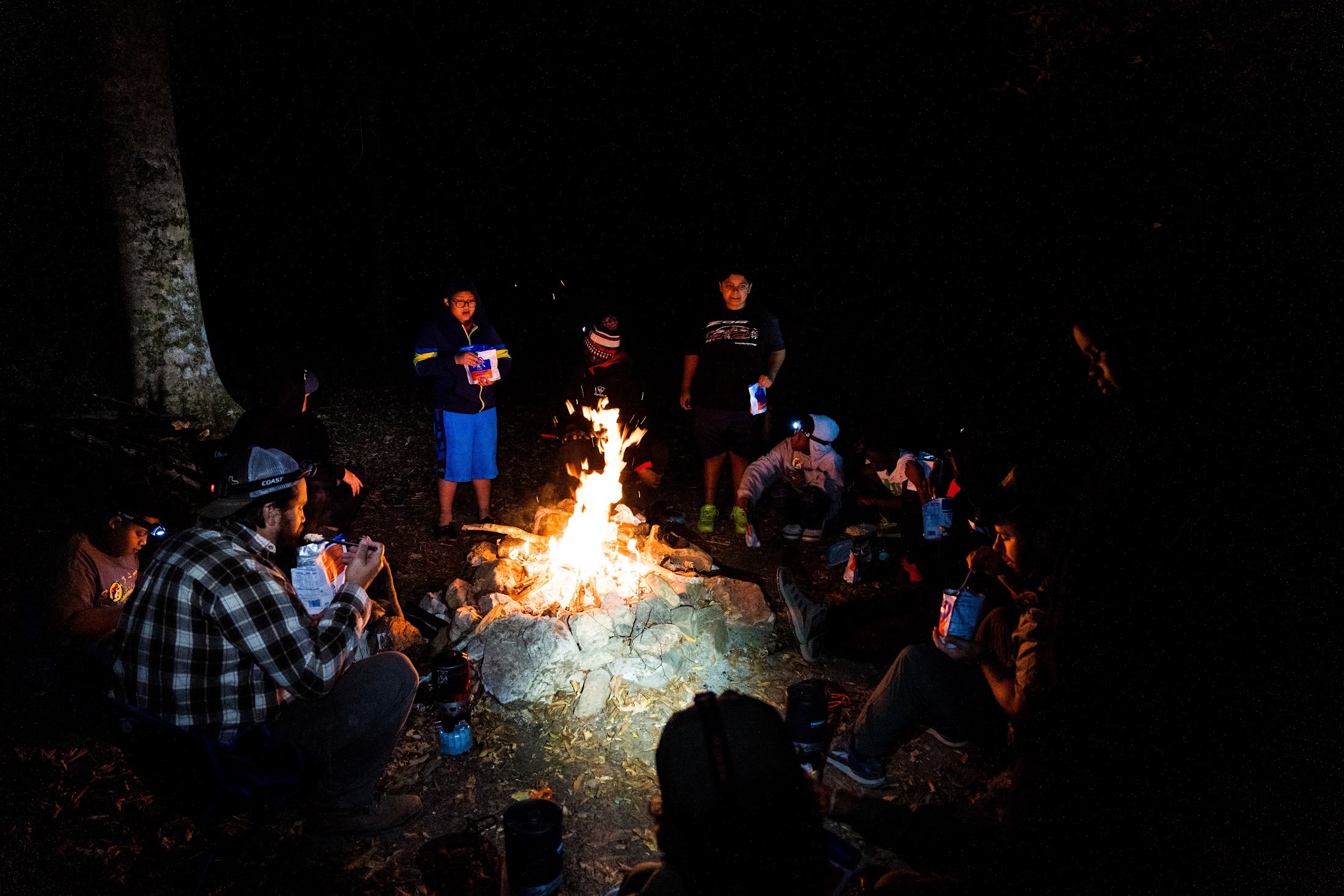Camp Firewalker participants enjoying an evening campfire