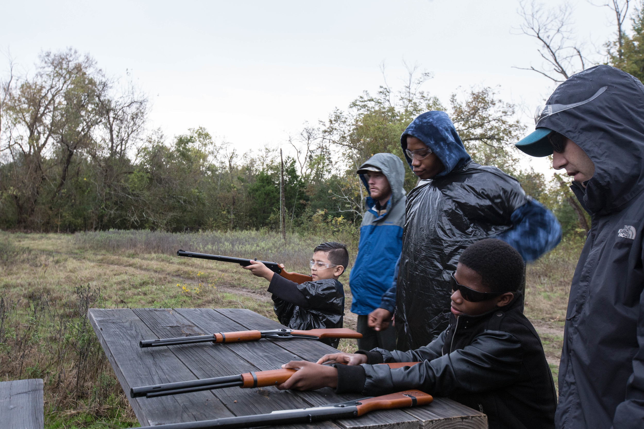 A young Camp Firewalker participant receiving supervised BB gun instruction
