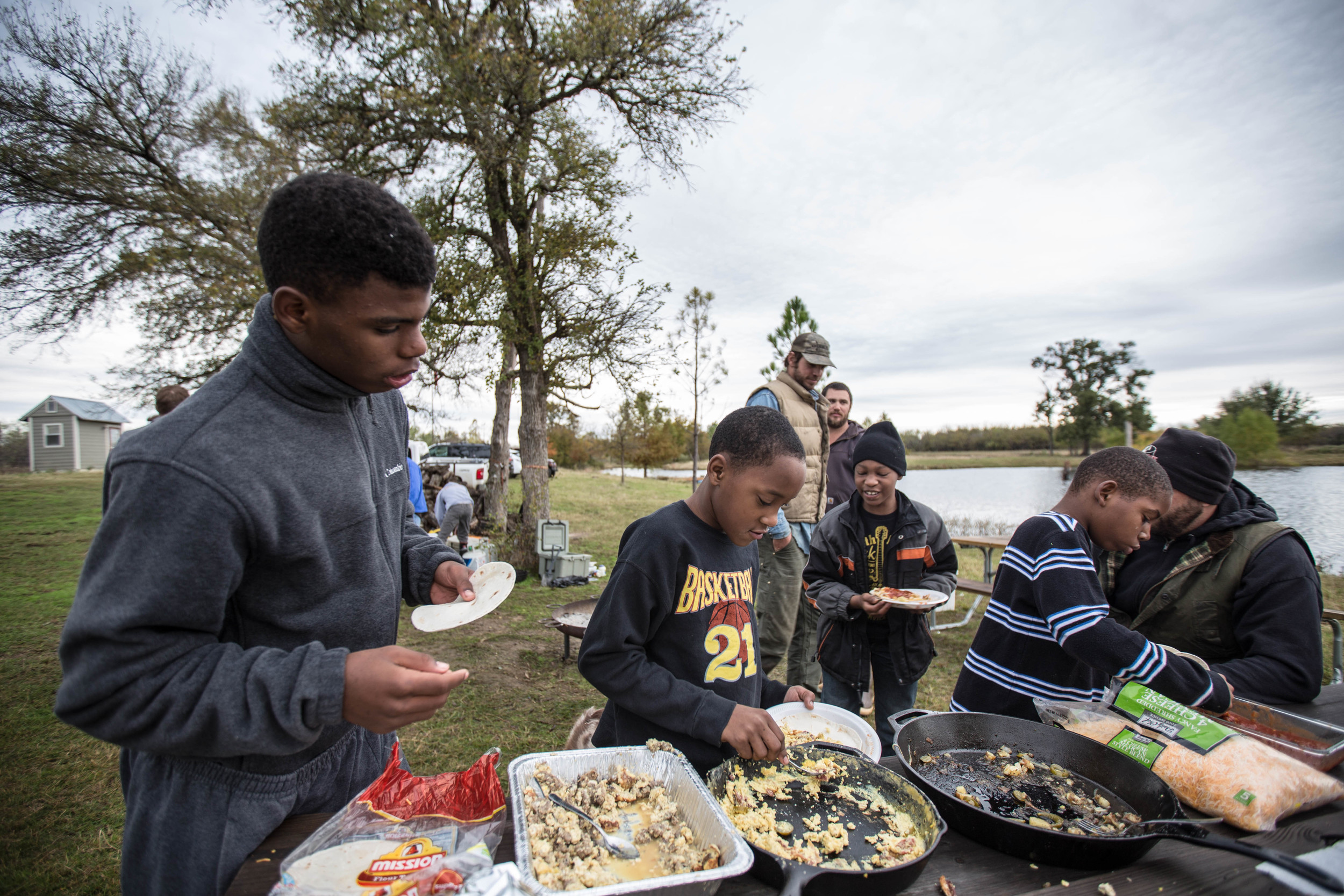 Camp Firewalker participants and volunteers gathered around a meal