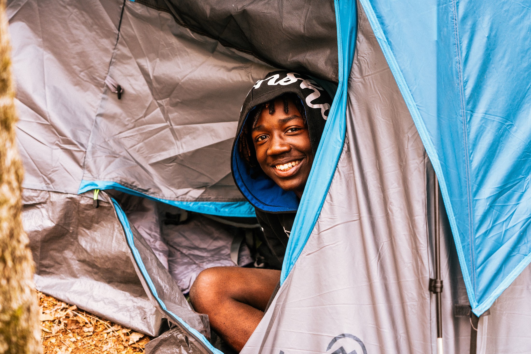 A Camp Firewalker participant outside a tent in the morning