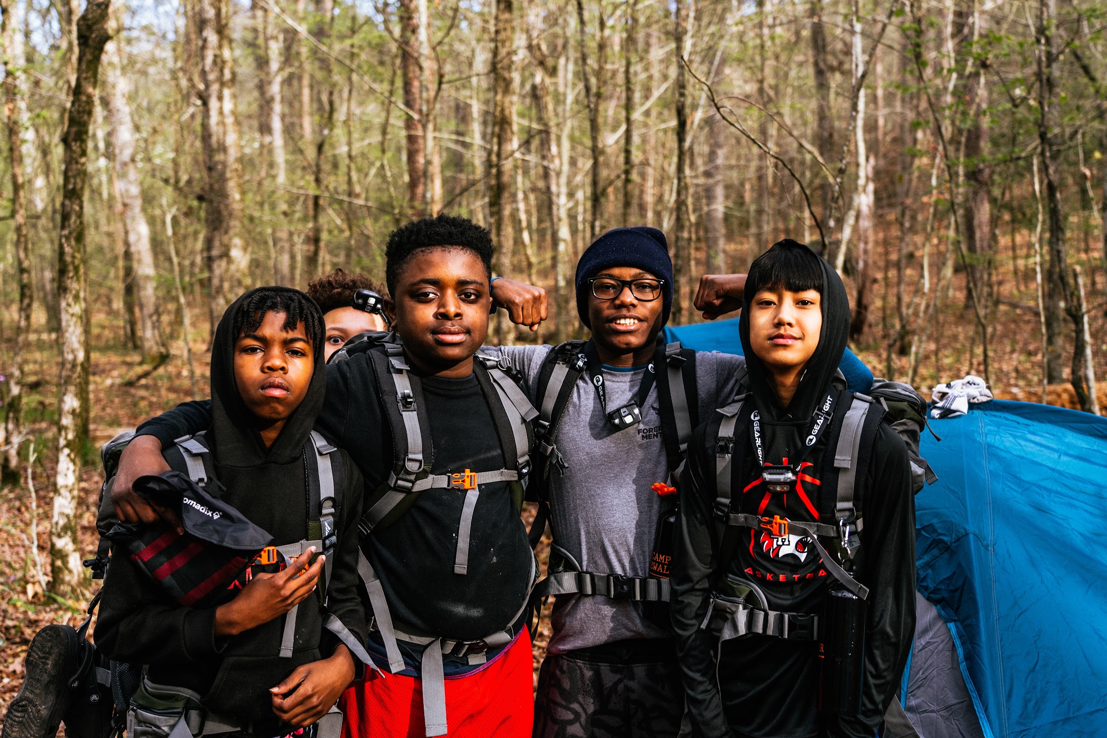 Camp Firewalker participants hiking together on a wooded trail